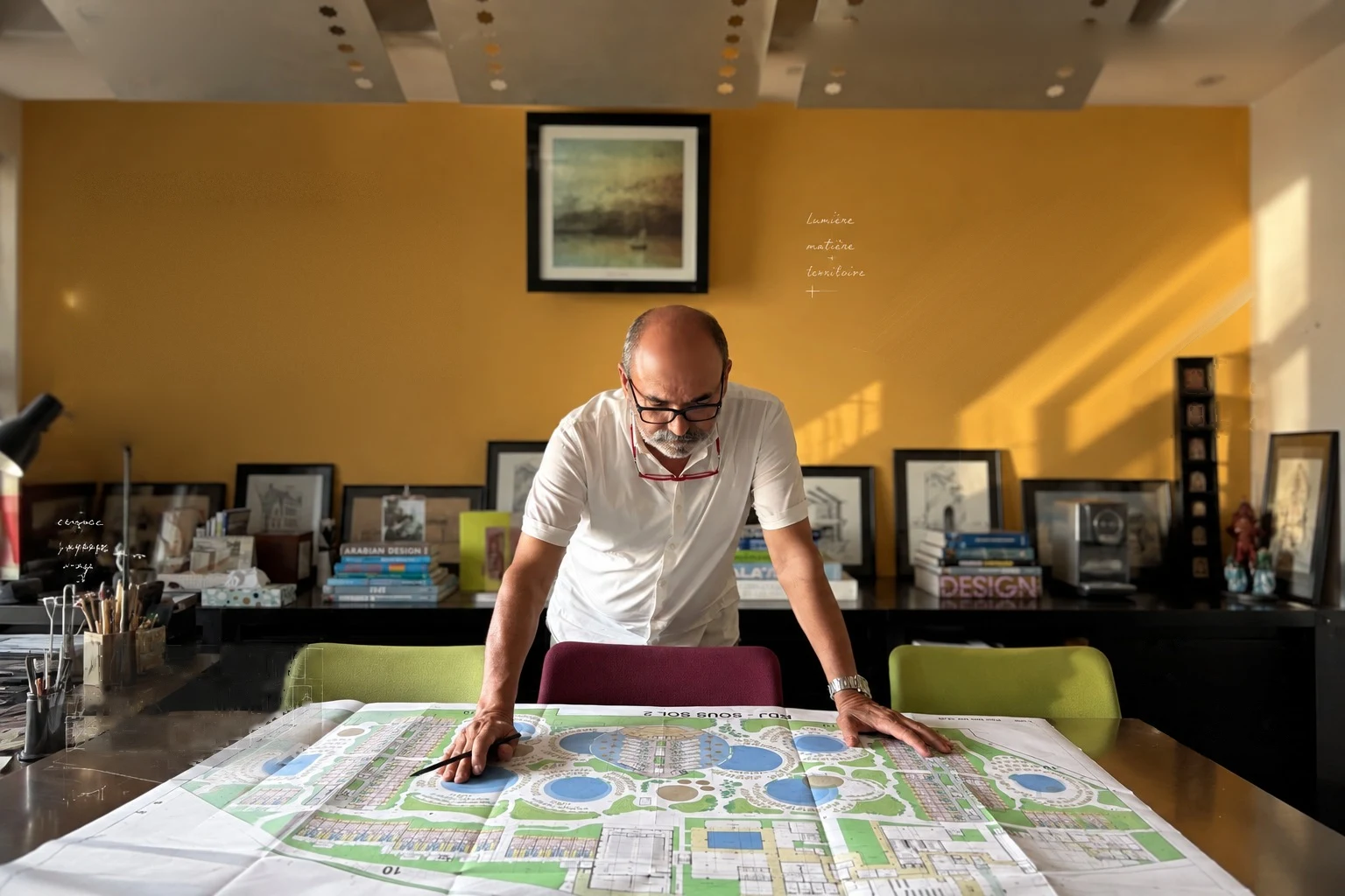 Ahmed Kharim, architect, studying a plan